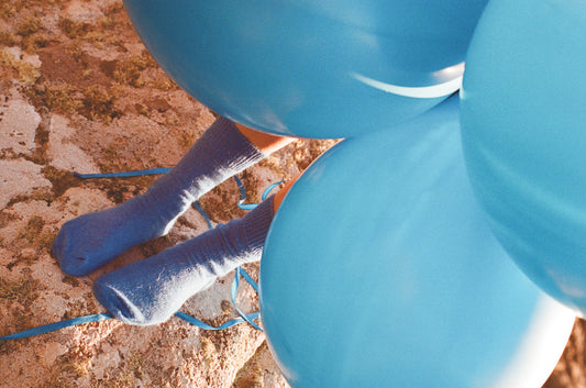 cobalt blue mohair socks on model with balloons